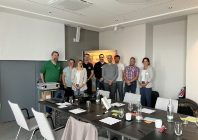 Let's talk Data Culture Workshop, Personen sitzen in großem Raum mit Tischgruppen und disktutieren